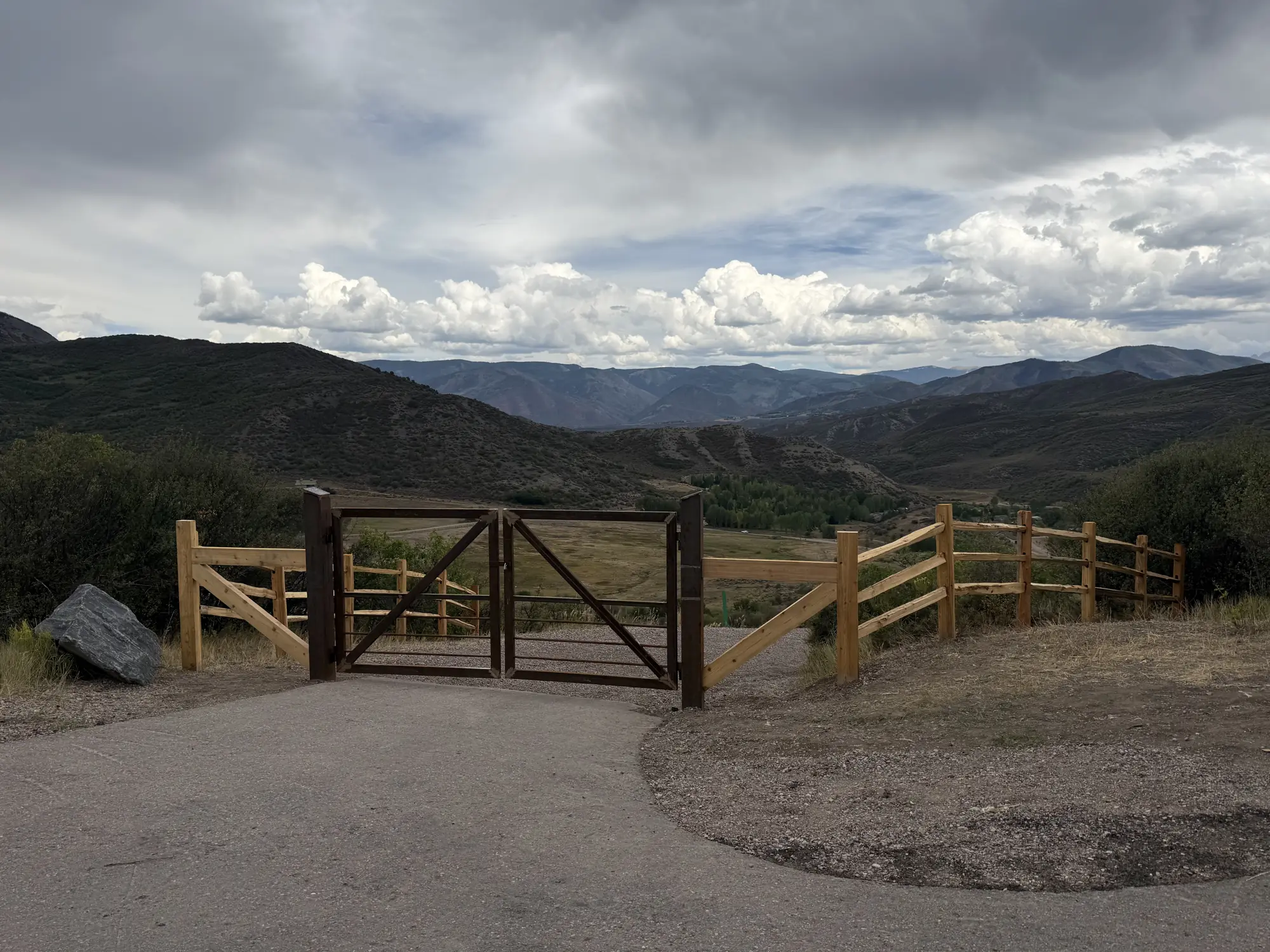Completed gate and driveway entrance above a valley